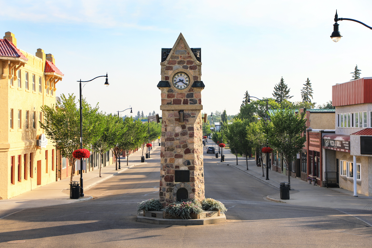 town centre clock in Wainwright in the middle of the road with buildings on either side