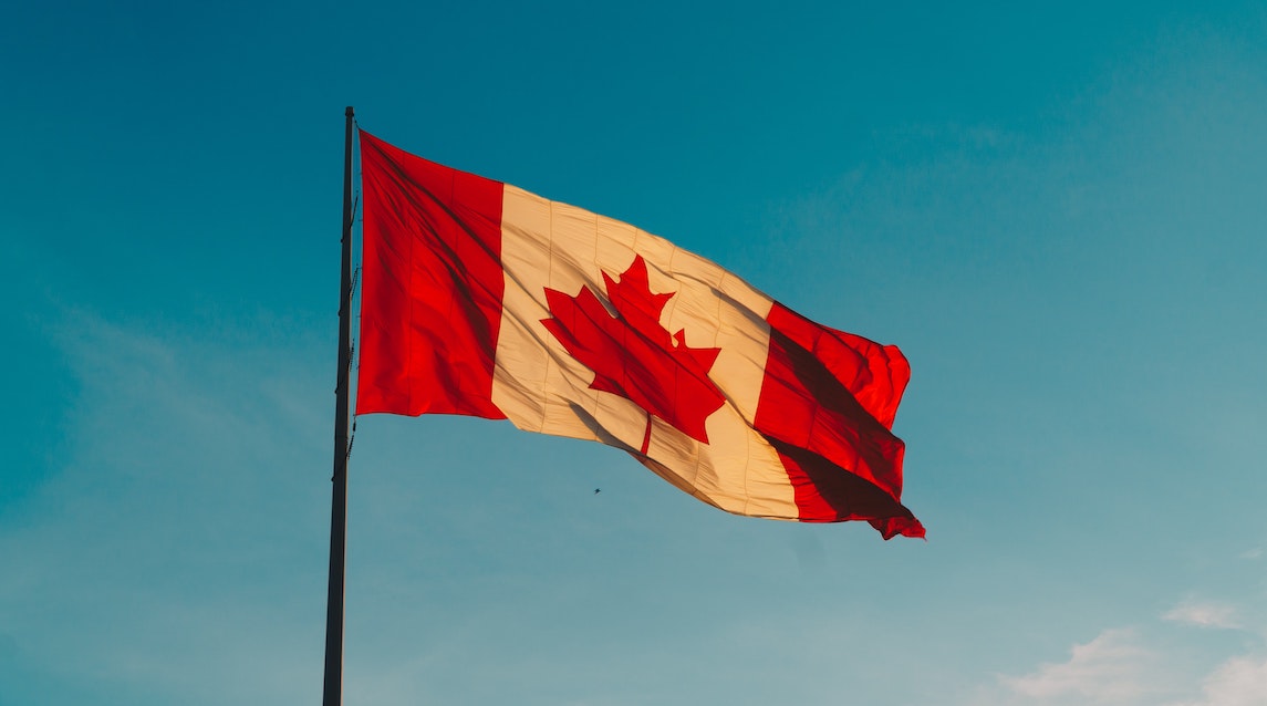 canadian flag against a blue sky